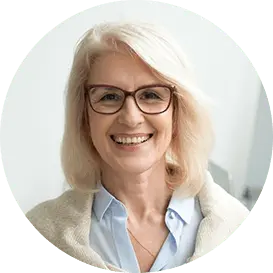 Confident aged businesswoman wearing glasses, a skilled and experienced senior female professional. A mature lady teacher and coach posing alone in the office, representing the image of a capable older woman boss in a headshot. Relevant for individuals seeking guidance and insights from a dissertation expert.